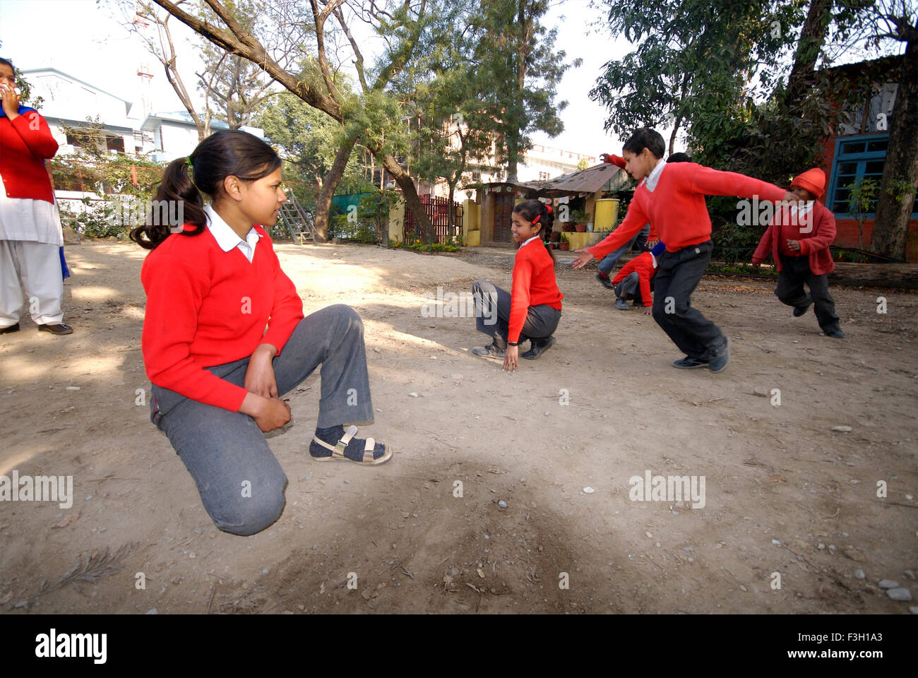 Students playing Kho Kho ; Nanhi Duniya school ; Doon School ; Dehradun ; Dera Doon, Uttaranchal, Uttarakhand, India, Asia, Asian, Indian ; MR#711 Stock Photo