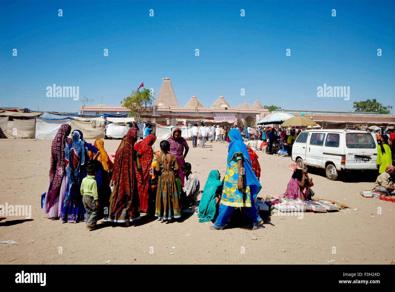 Women buying accessories at Macker dada temple ; Rann Utsav, Dhrang Rann ; Kutch ; Gujarat ; India Stock Photo