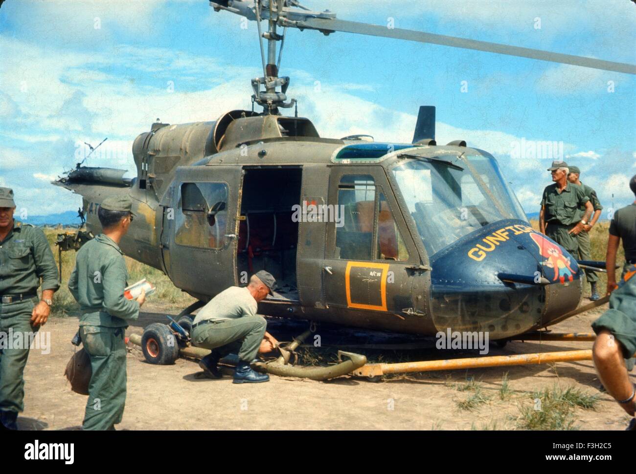 US army soldiers look at Bravo Troop, 1st Squadron, 9th Cavalry, 1st Cavalry Division helicopter gunship crashed. An Khe Vietnam 1966. Stock Photo