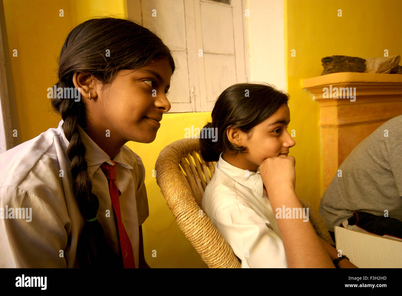 Girls listening to music ; Nanhi Dunya school ; Doon School ; Dehradun ; Dera Doon, Uttaranchal, Uttarakhand, India, Asia, Asian, Indian ; MR#711 Stock Photo