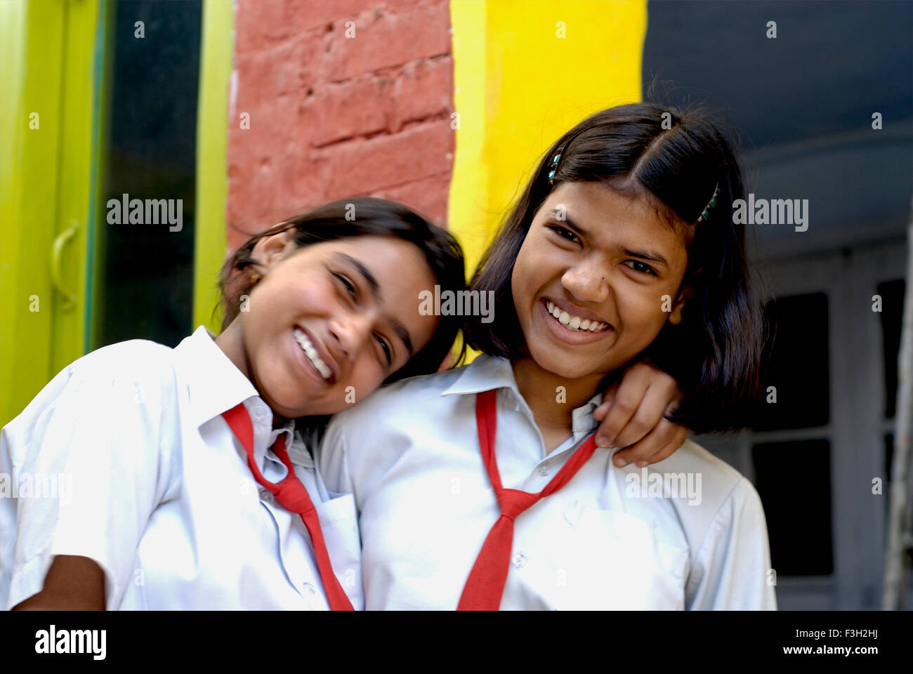 Two girls laughing ; Nanhi Dunya school ; Doon School ; Dehradun ; Dera Doon, Uttaranchal, Uttarakhand, India, Asia, Asian, Indian ; MR#711 Stock Photo