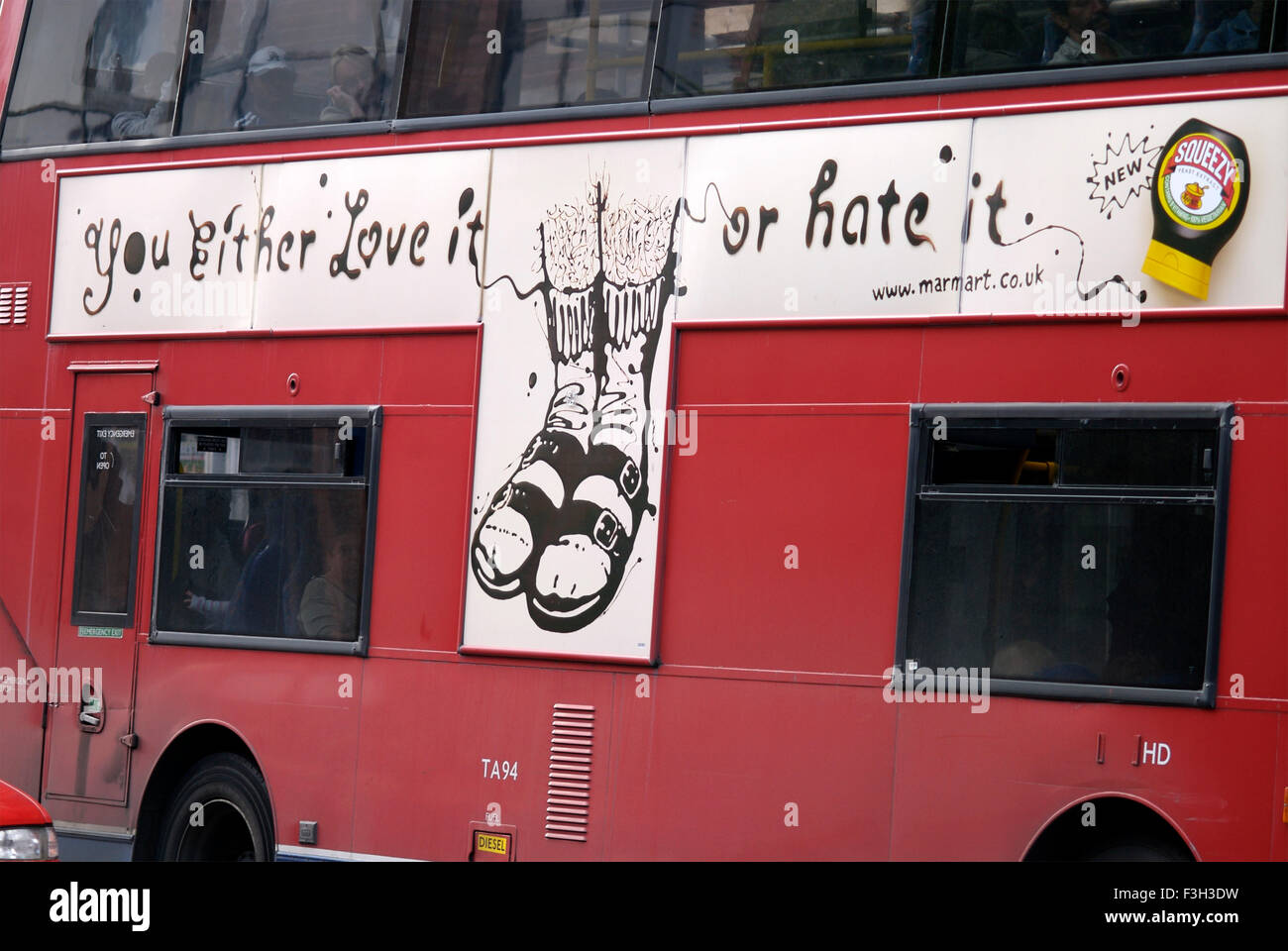 Red bus with advertising saying you Either Love It Or hate It ; London ; U.K. United Kingdom England Stock Photo