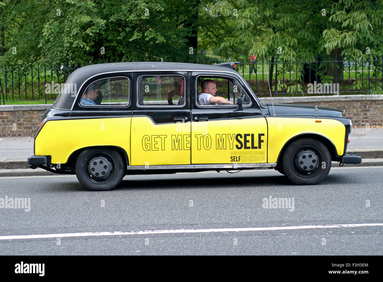 Black and yellow taxi with Get Me TO Myself Caption ; London ; U.K. United Kingdom England Stock Photo
