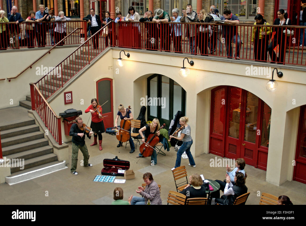 Musicians Entertain viewers by playing Violins at Convent Garden ; London ; U.K. United Kingdom England Stock Photo