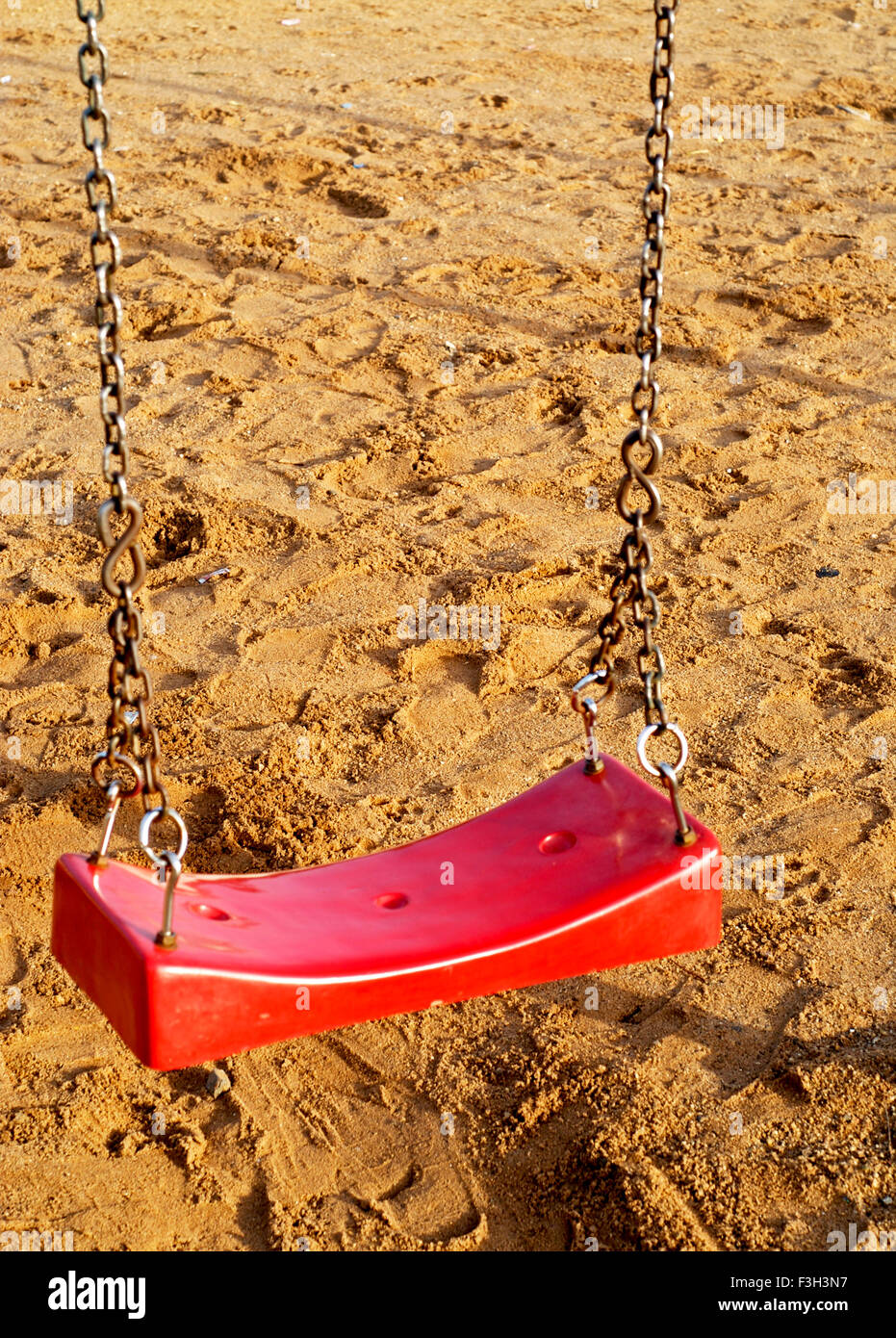 Plastic red seat of swing for children at race course ground ; Rajkot ; Gujarat ; India Stock Photo
