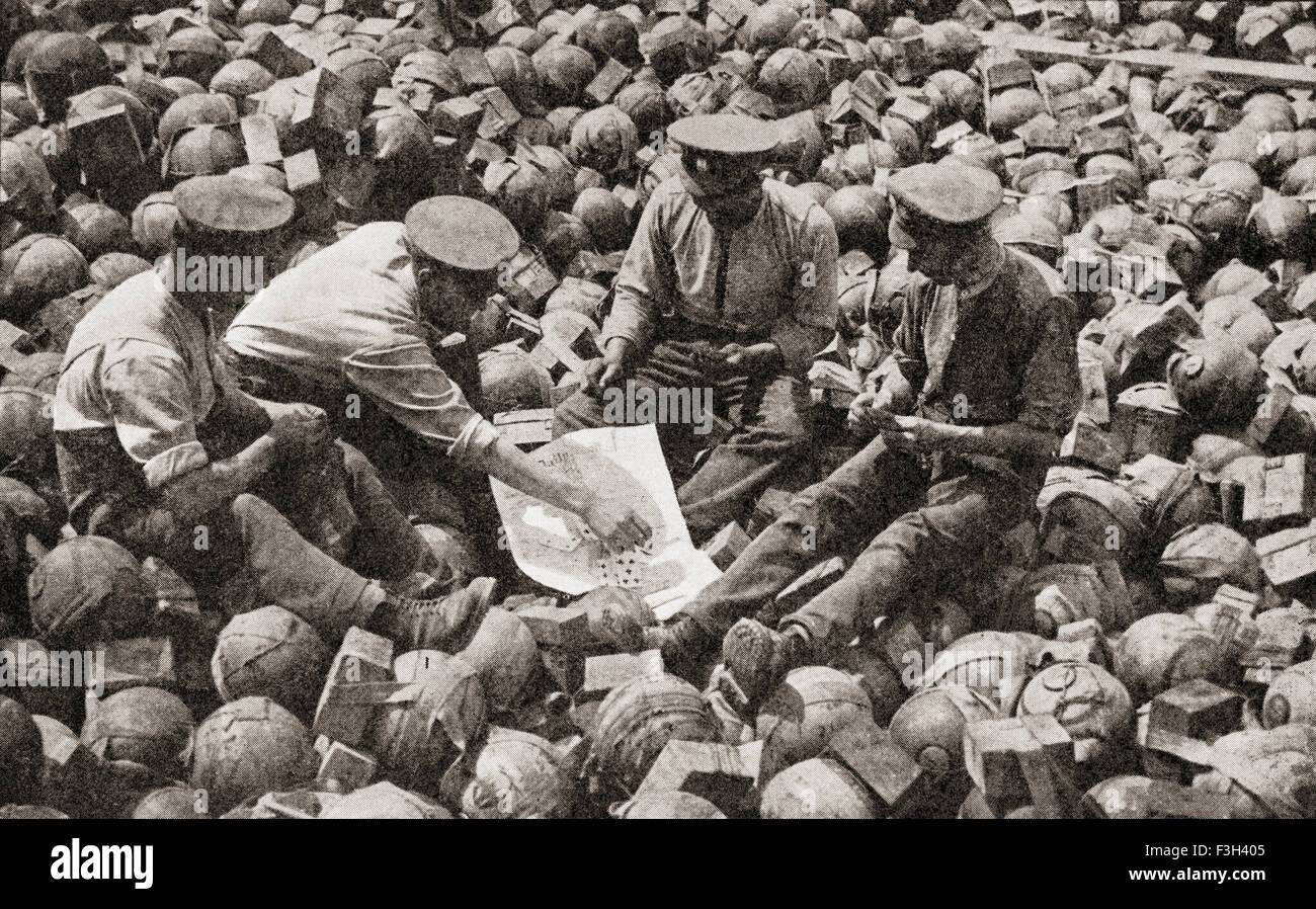 British soldiers, sat on captured German equipment, playing a game of cards during WWI. Stock Photo