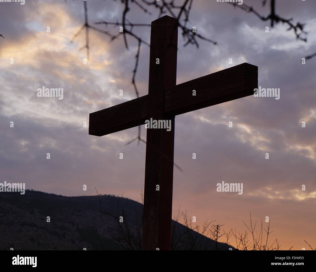 Cross at sunset Stock Photo - Alamy