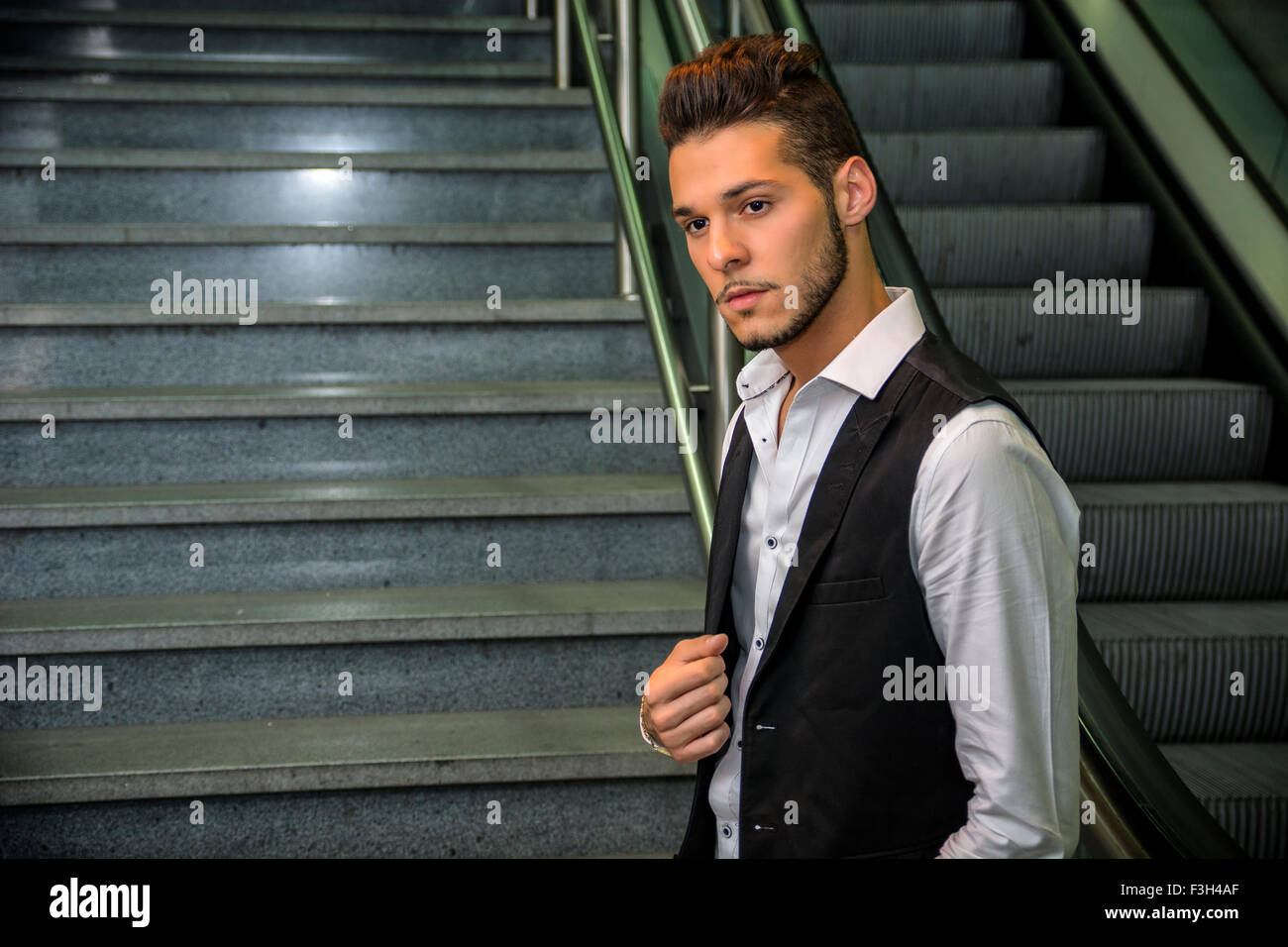 Profile shot of handsome young man inside train station looking at camera Stock Photo