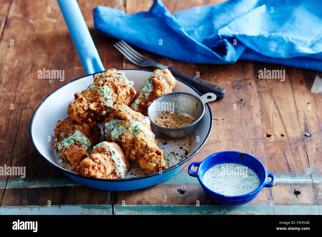 Cajun fried chicken with green chilli dressing Stock Photo