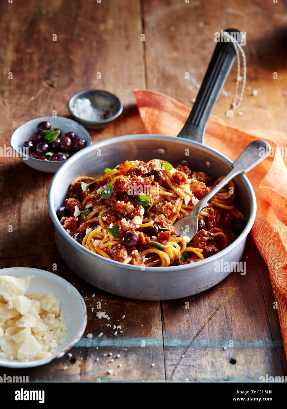 Spaghetti with italian sausage and ligurian olives Stock Photo