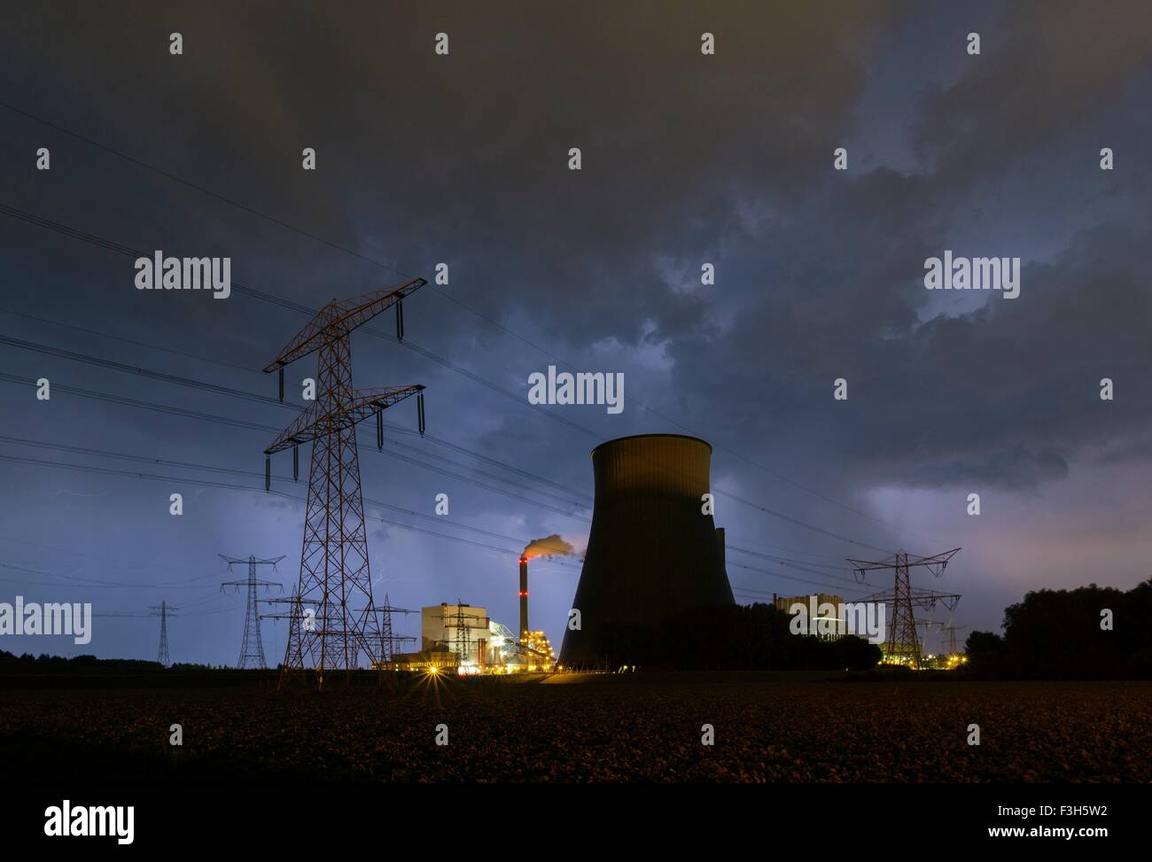A thunderstorm hits a coal-fired power station at night Stock Photo