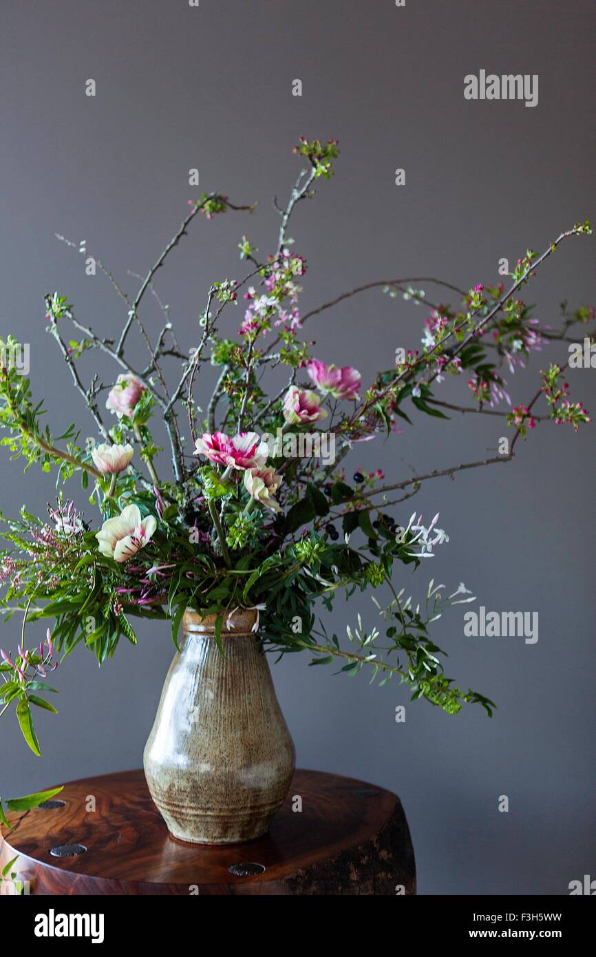 Flowers in vase on wood table Stock Photo