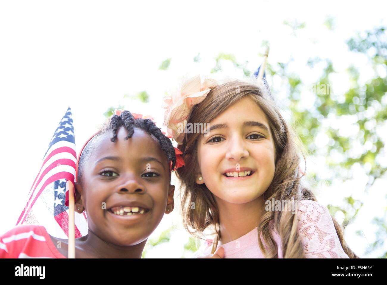 Portrait of girl with American flag in park Stock Photo