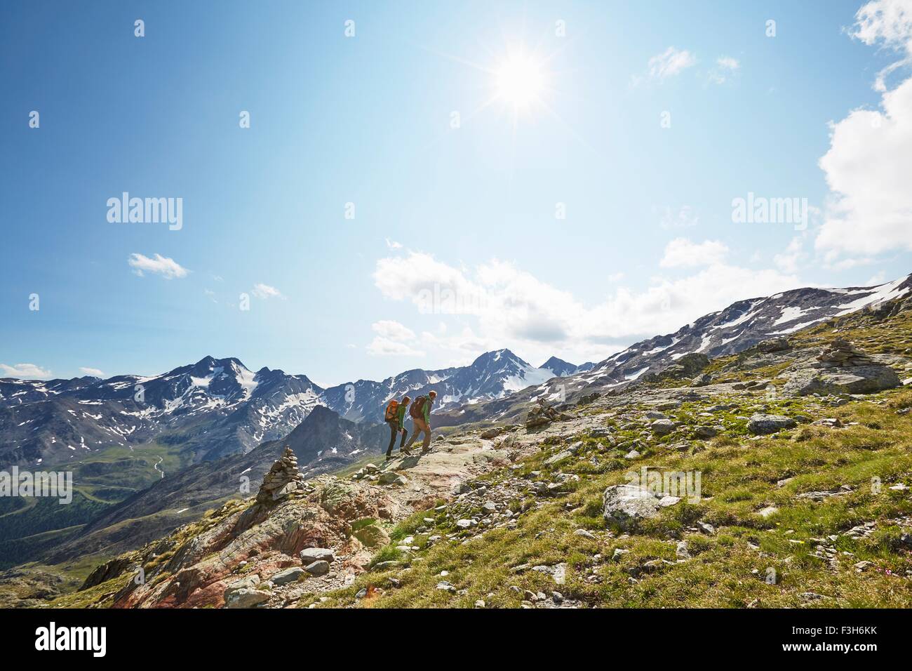 Young couple hiking up Val Senales Glacier, Val Senales, South Tyrol, Italy Stock Photo