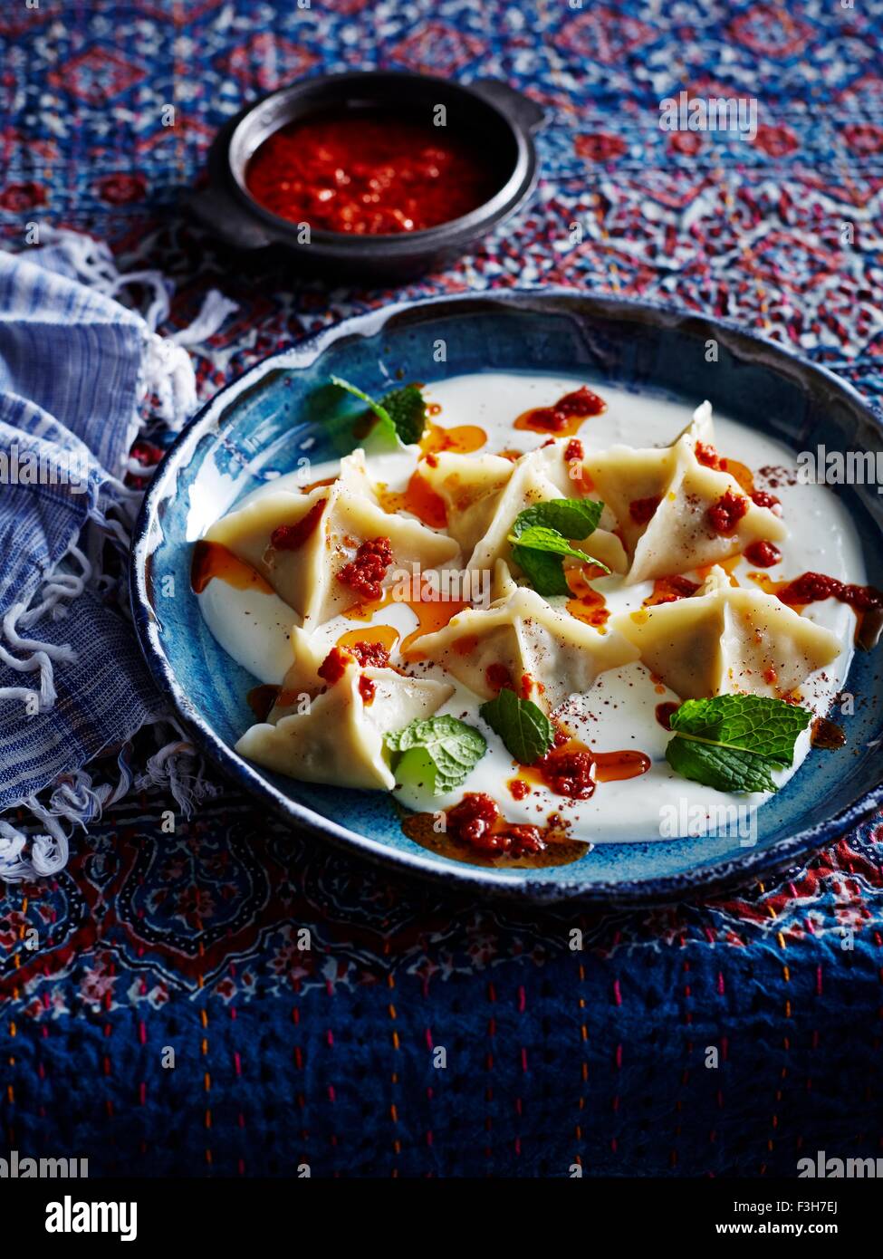 Turkish lamb manti with tomato and aleppo Stock Photo