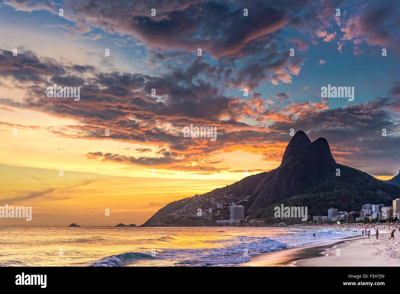View of Ipanema Beach and Padre Dois Irmaos against dramatic sky, Rio De Janeiro, Brazil Stock Photo