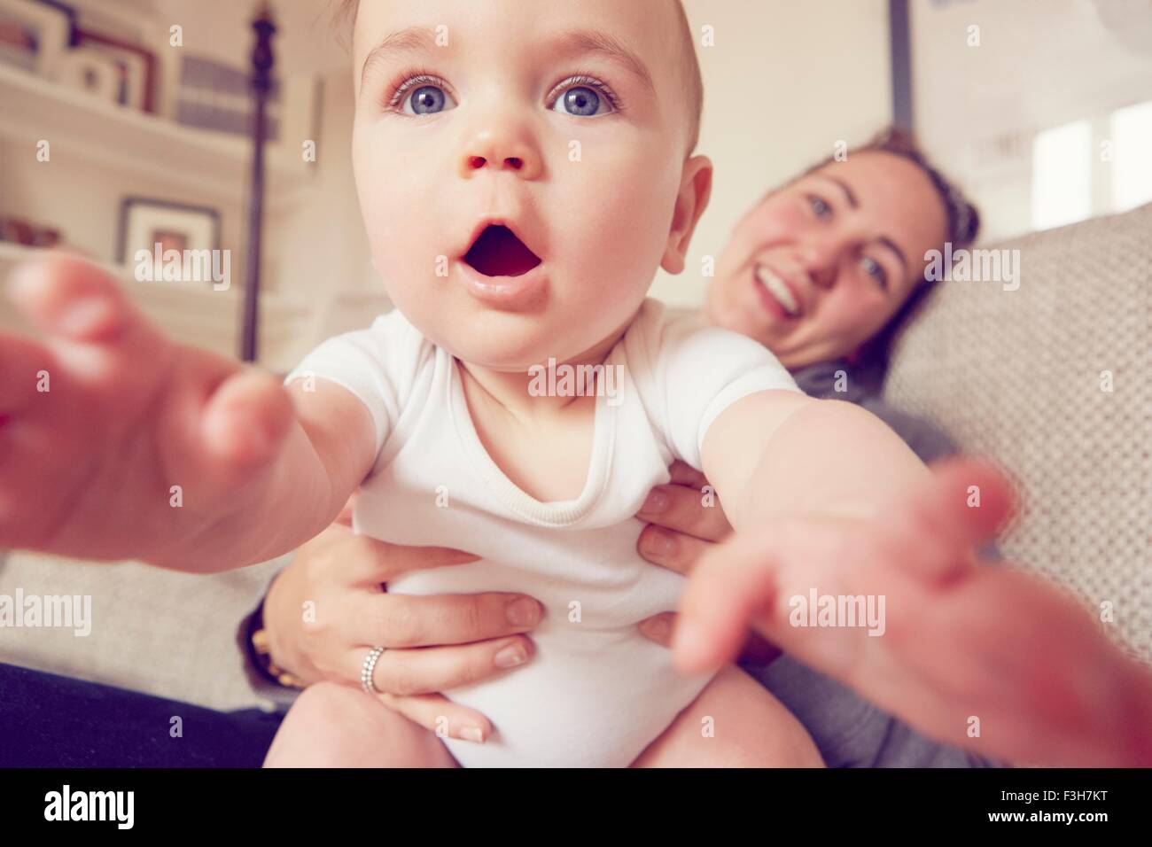 Mother and baby boy playing in living room Stock Photo