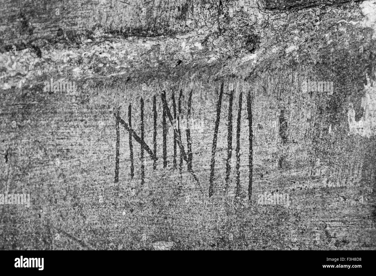 Tally marks on brick wall Stock Photo - Alamy