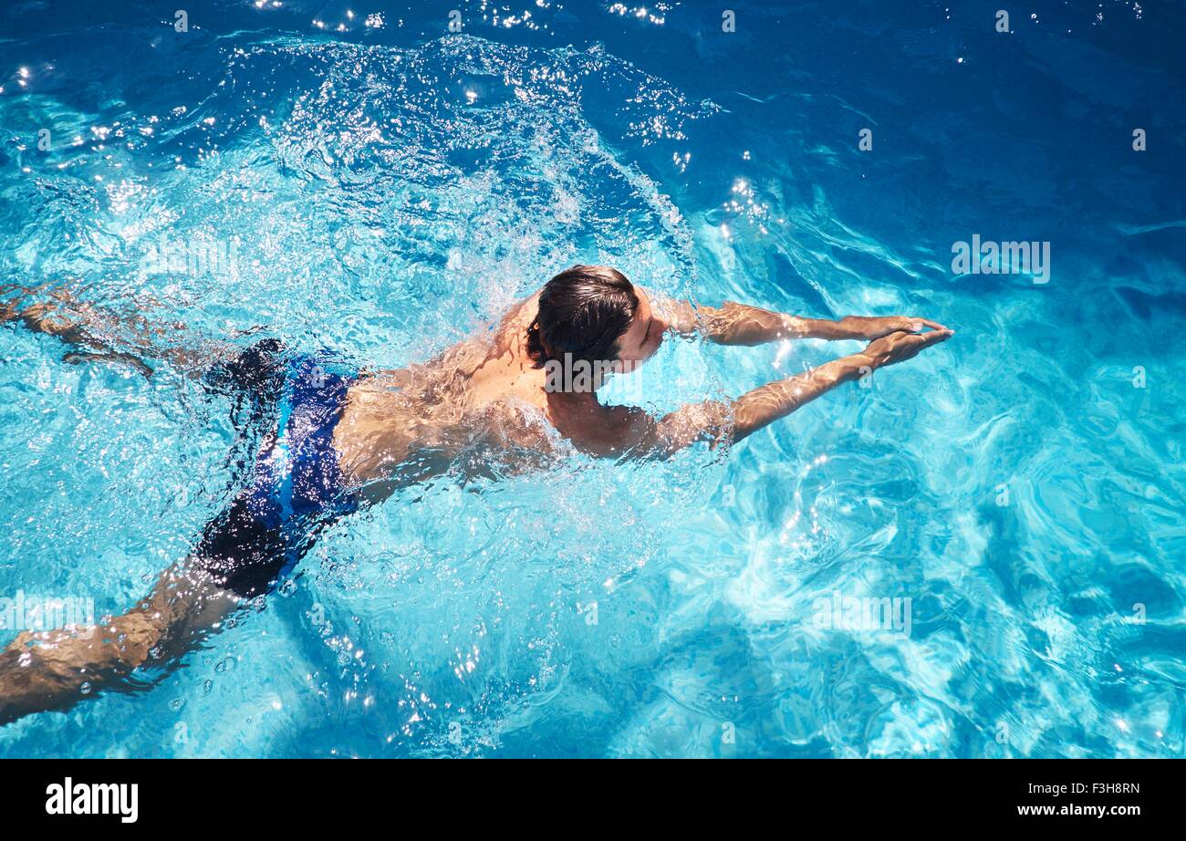 Overhead view of young man swimming in swimming pool Stock Photo