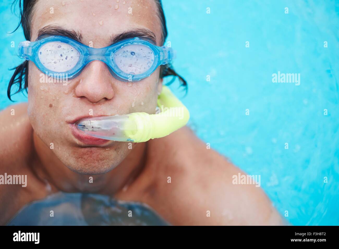 Portrait of young man wearing scuba goggles in swimming pool Stock Photo