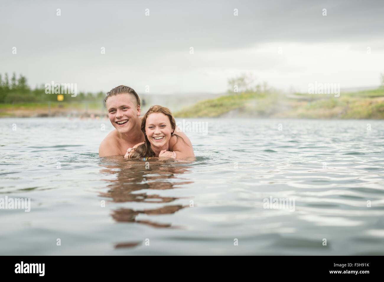 Young couple in Secret Lagoon hot spring (Gamla Laugin), Fludir, Iceland Stock Photo