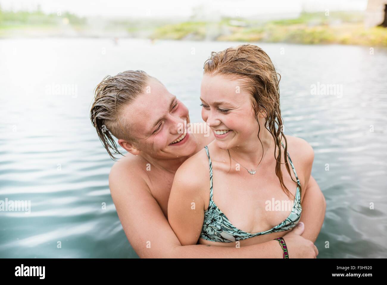 Romantic young couple in Secret Lagoon hot spring (Gamla Laugin), Fludir, Iceland Stock Photo