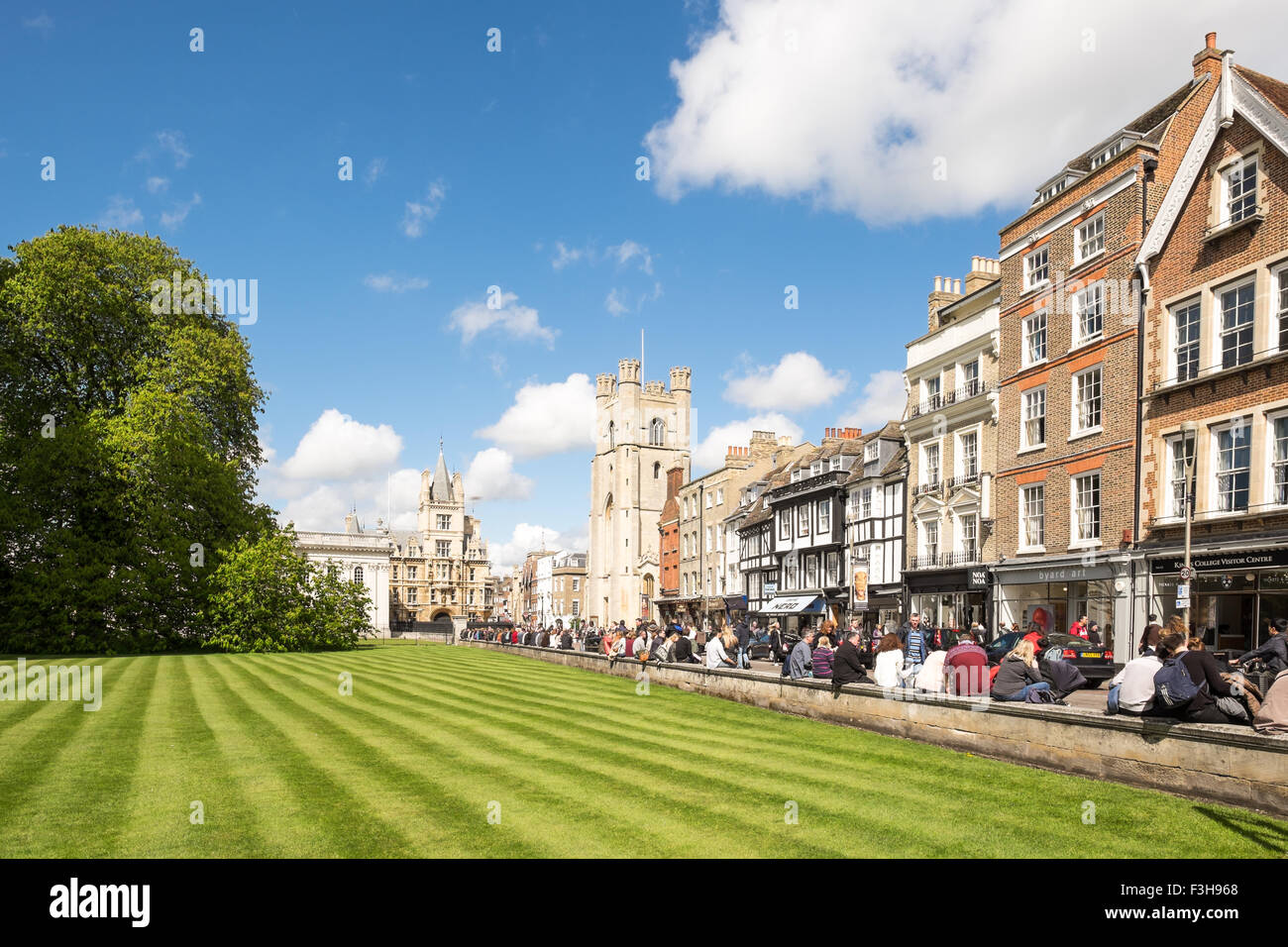 View of kings parade from Kings college Cambridge with blue sky and stripped lawn and tourists Stock Photo