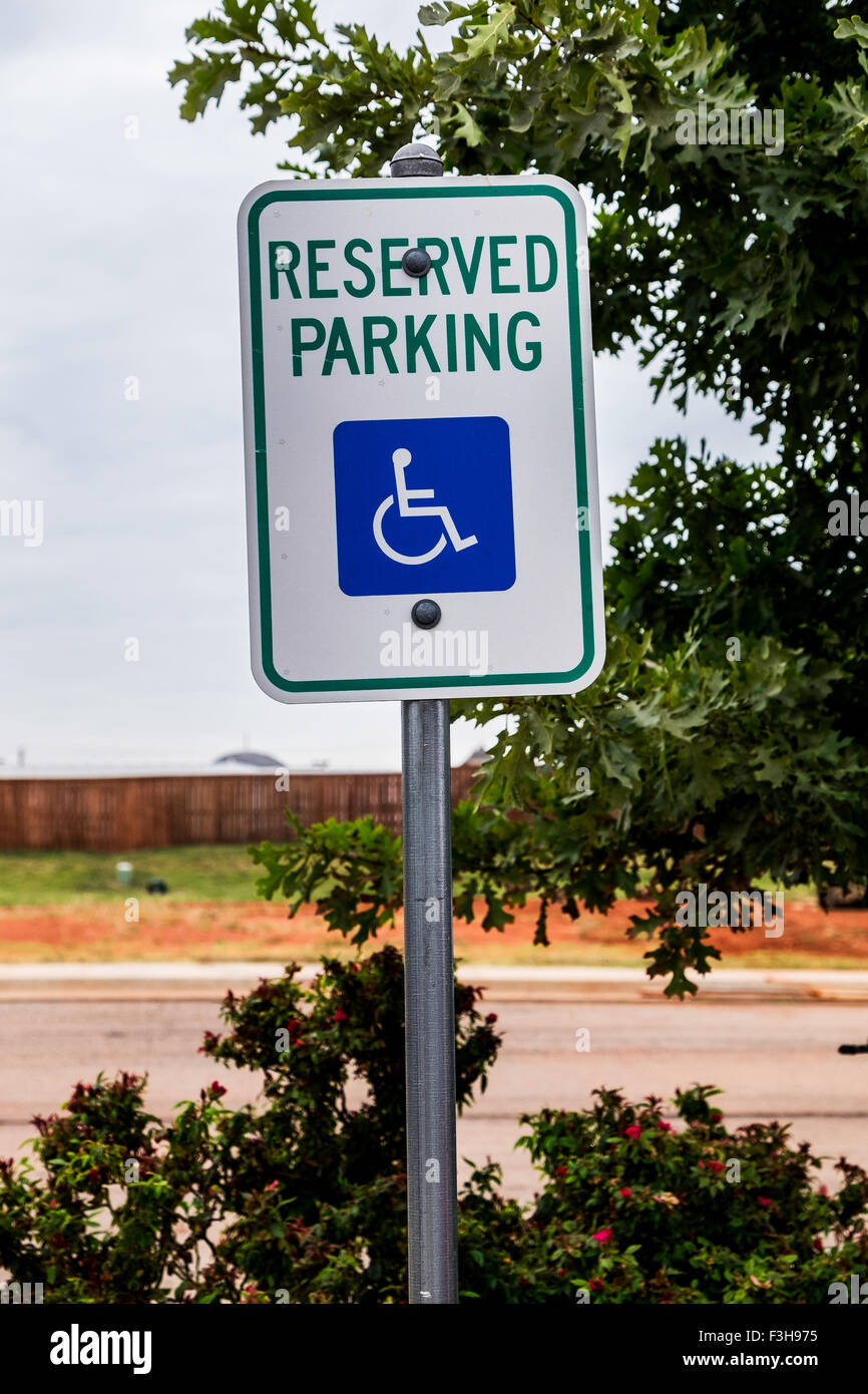A pole sign stating "reserved parking" for the handicapped in Oklahoma
