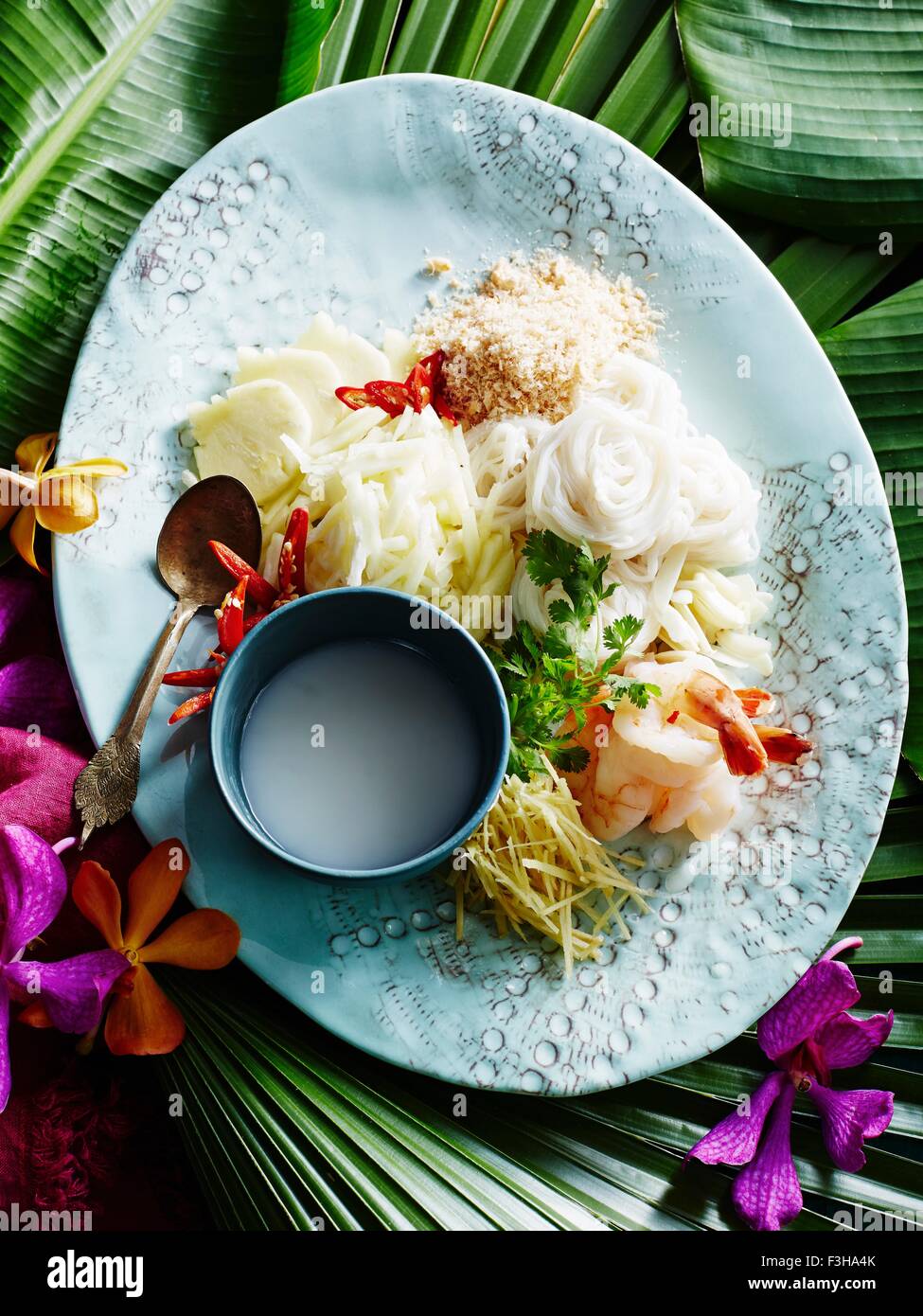 Still life of plate with raw ingredients for Kha Nhom Sao Nahm Stock Photo