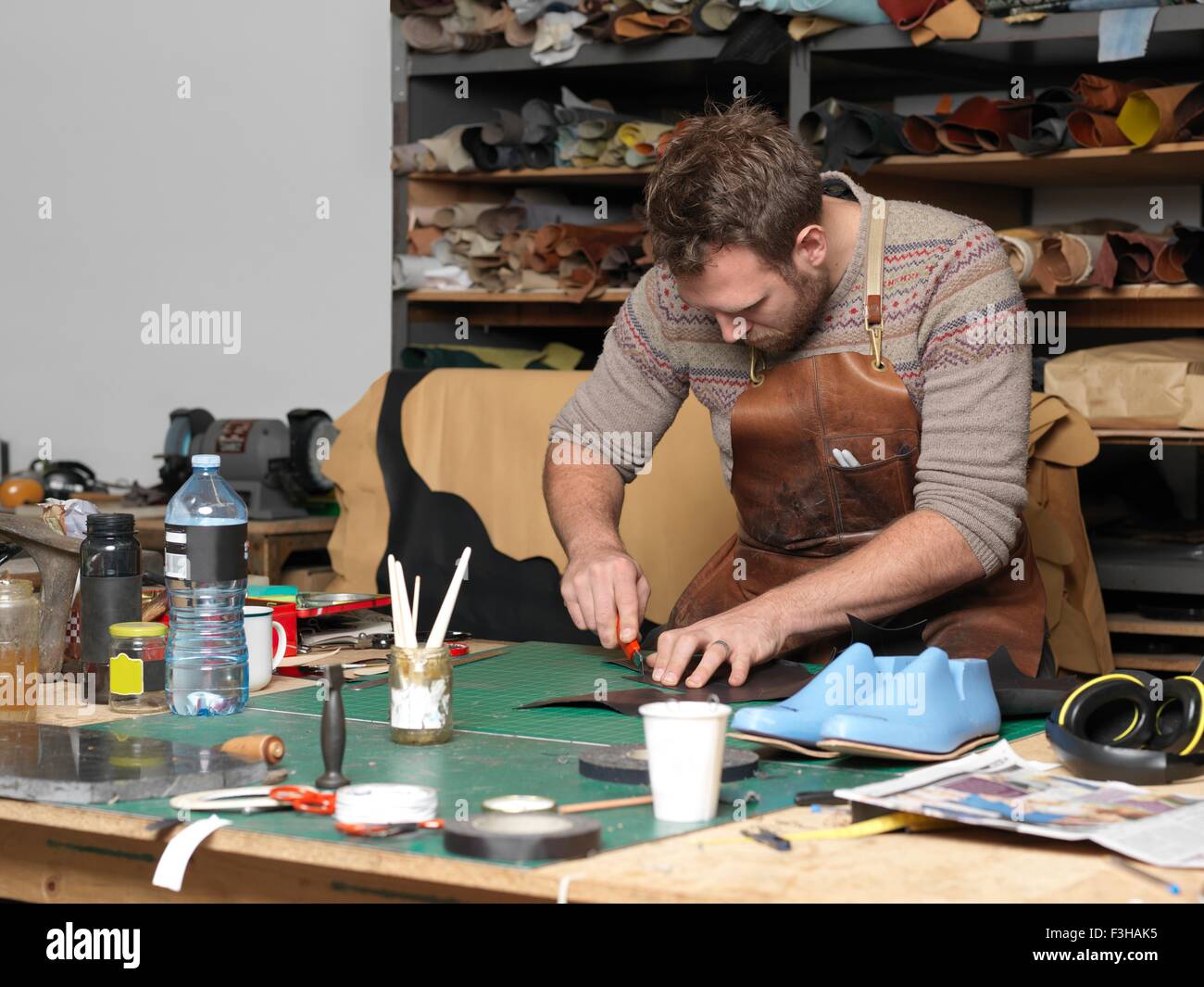 Shoemaker working in workshop Stock Photo