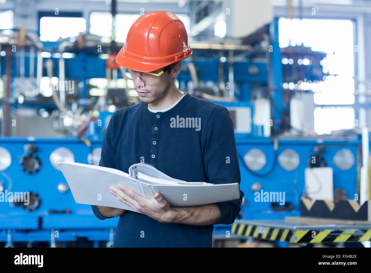 Factory engineer reading machinery instruction manual Stock Photo Alamy