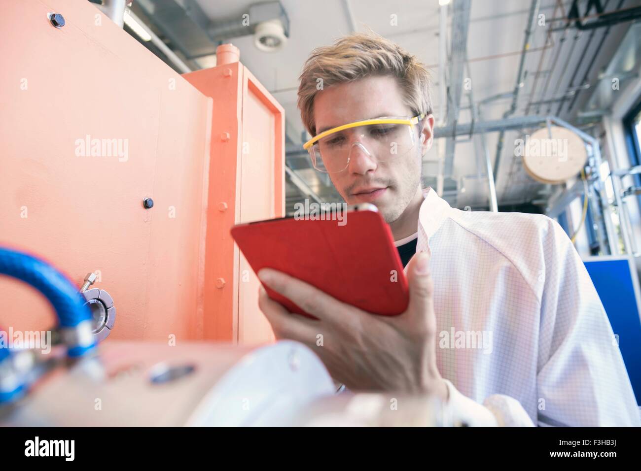 Factory technician using digital tablet Stock Photo