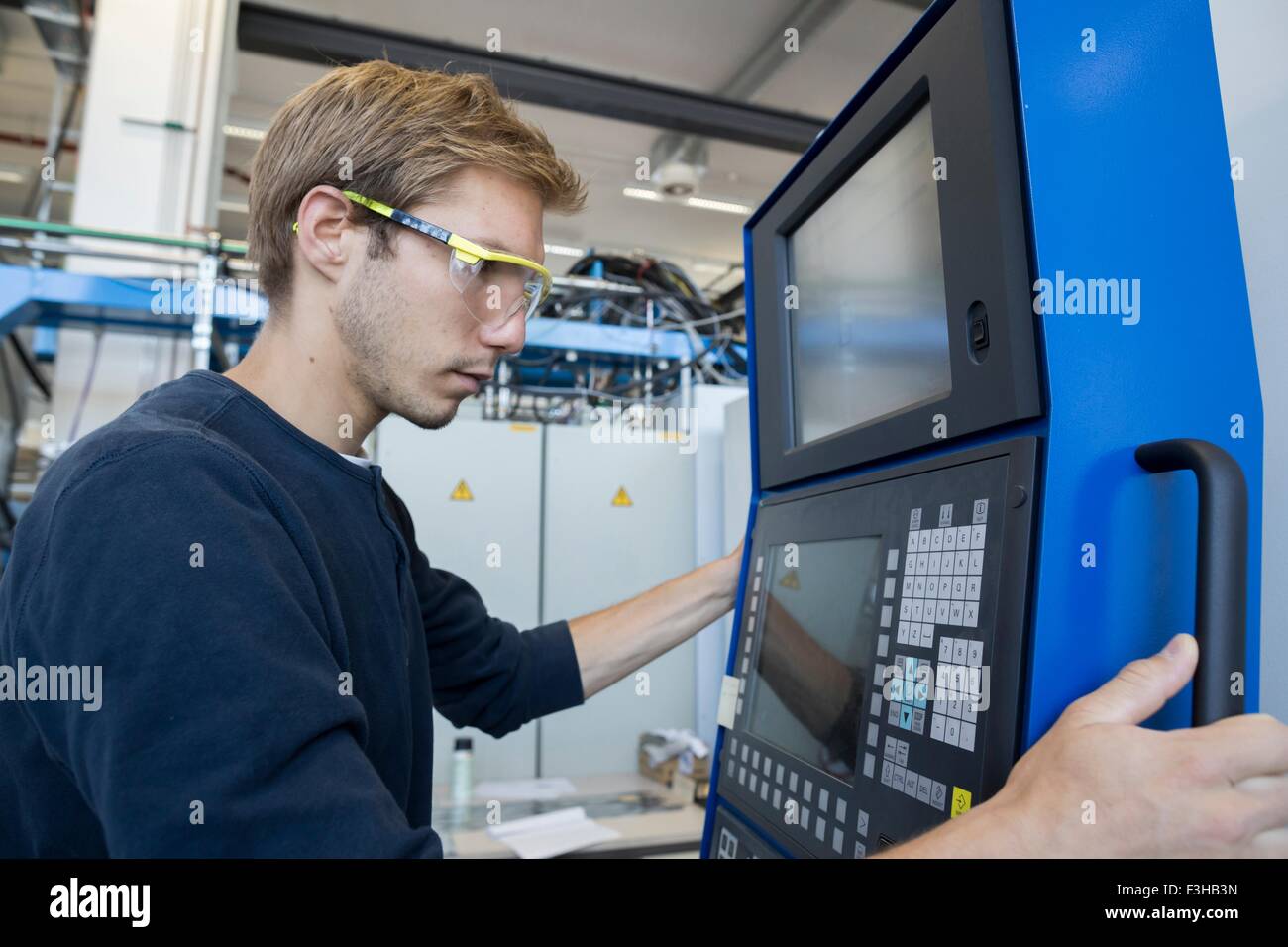 Factory technician working on control panel Stock Photo Alamy