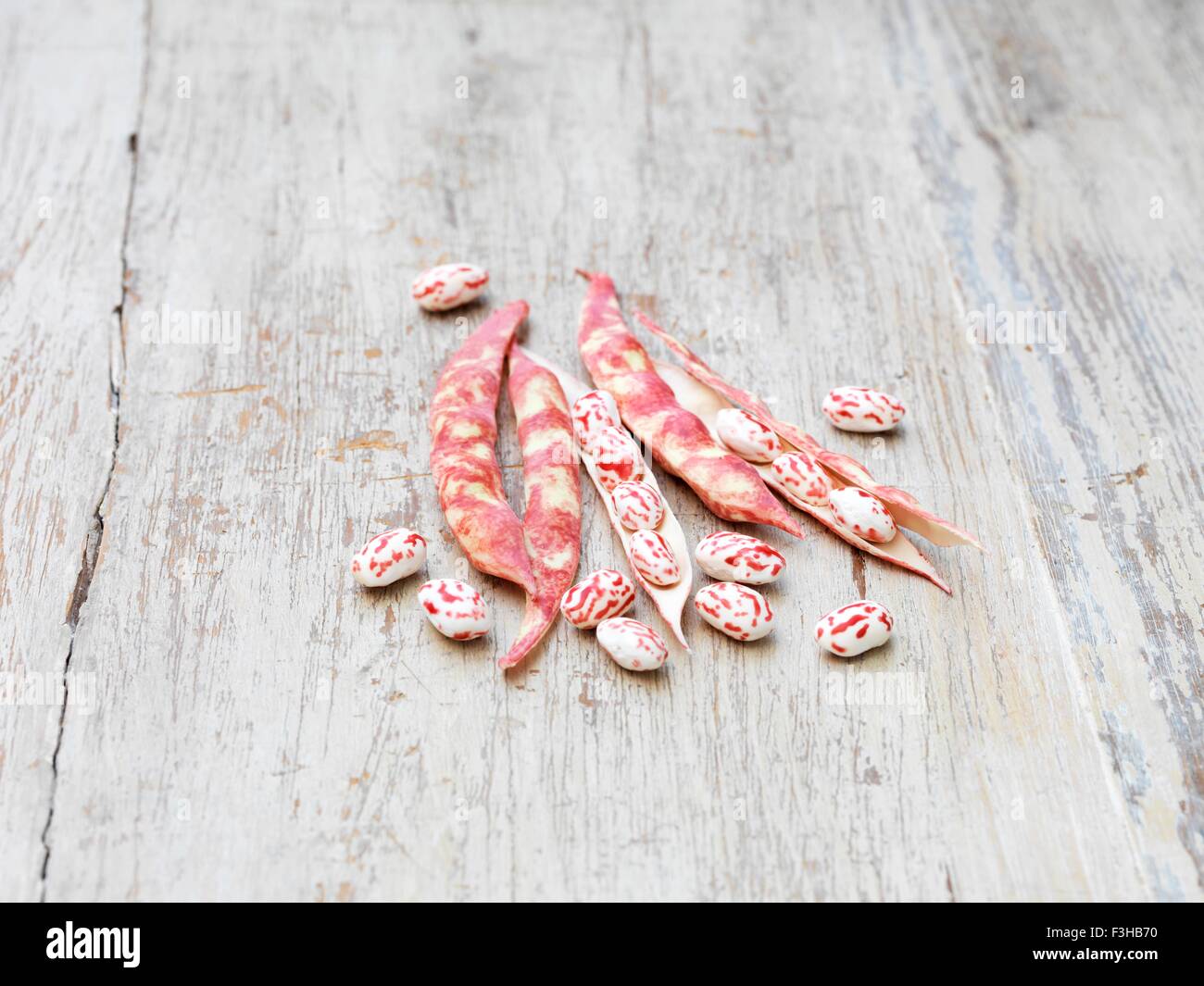 Still life of borlotti beans (also known as cranberry beans, roman beans or romano beans) on wooden table Stock Photo