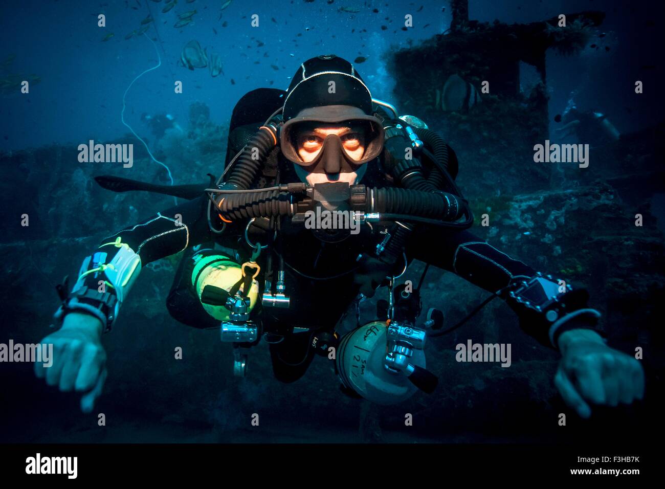 Underwater portrait of technical diver using a rebreather device to