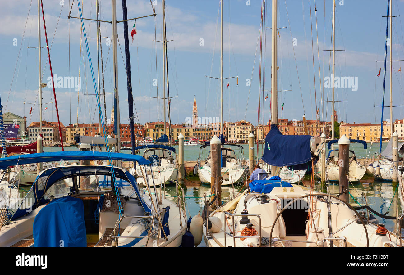 Venice waterfront seen through yachts in the harbour of San Giorgio Maggiore Island Veneto Italy Europe Stock Photo