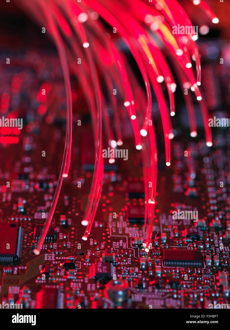 Fibre optics flowing through circuit boards from a laptop computer, close-up Stock Photo