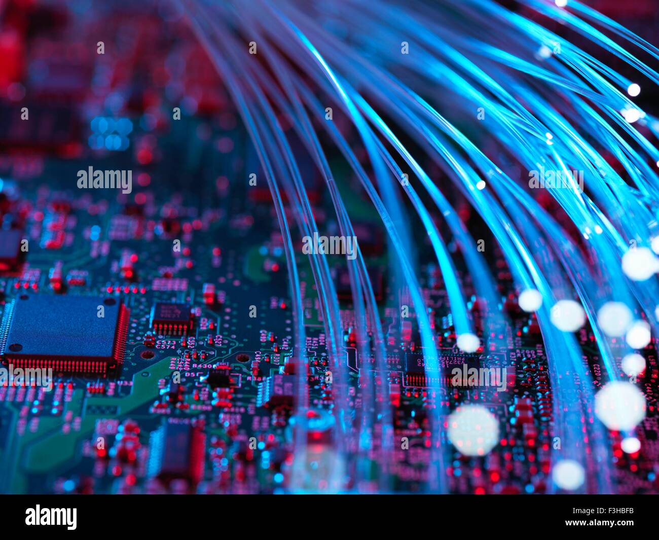 Fibre optics flowing through circuit boards from a laptop computer, close-up Stock Photo