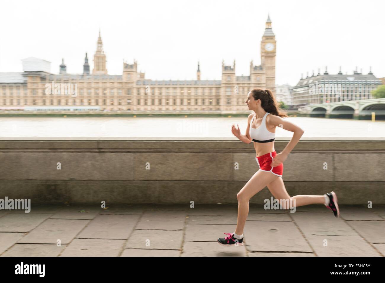 Female runner running on Southbank, London, UK Stock Photo