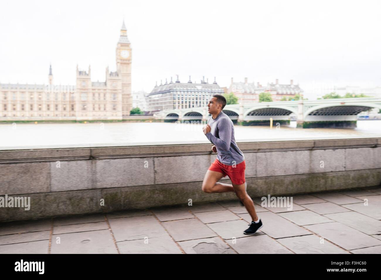 Male runner running on Southbank, London, UK Stock Photo