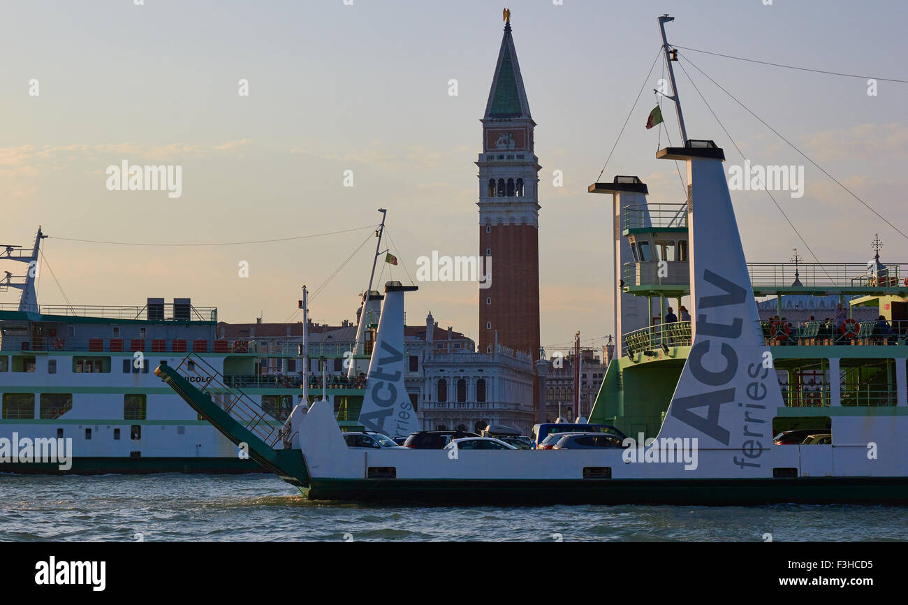 Two car ferries passing St Mark's Campanile at dusk Venice Veneto Italy Europe Stock Photo