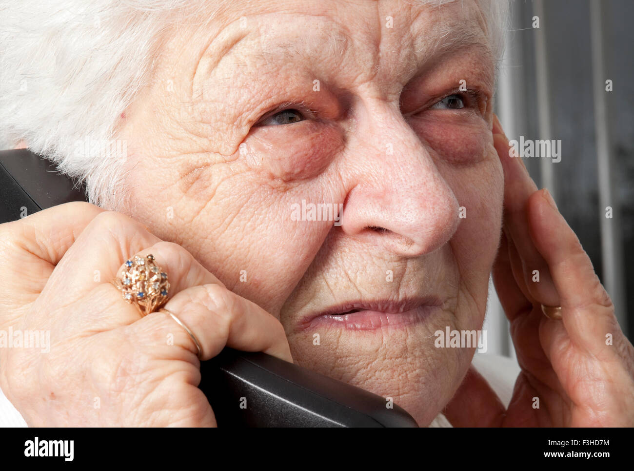 pensive elderly woman calling on the phone Stock Photo