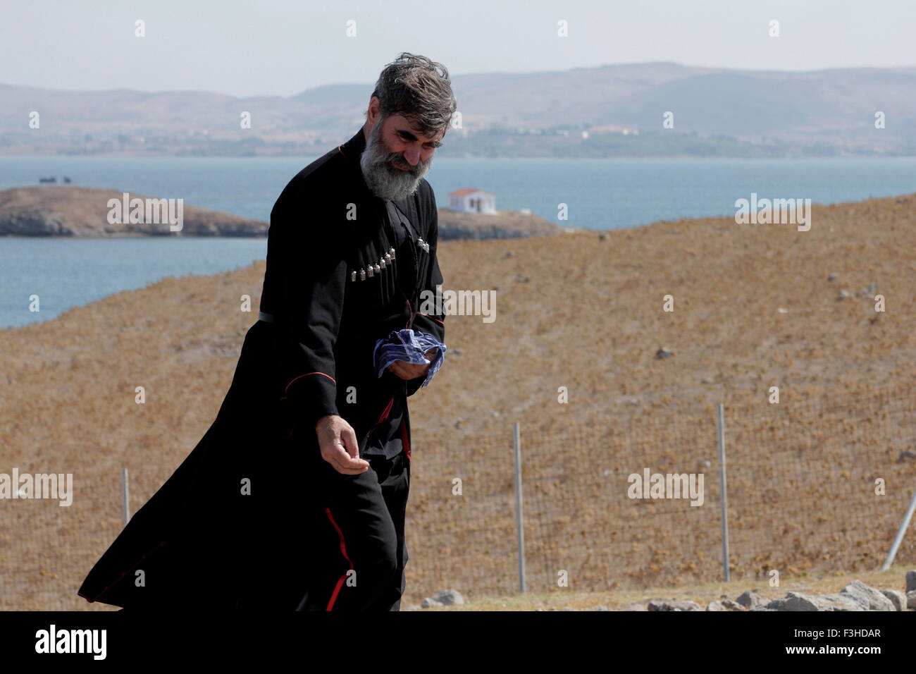 Kozak throws a handful of dirt, on each grave of all those who rest in