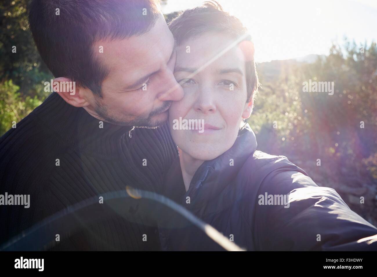 Tender sunlit portrait of adult couple Stock Photo