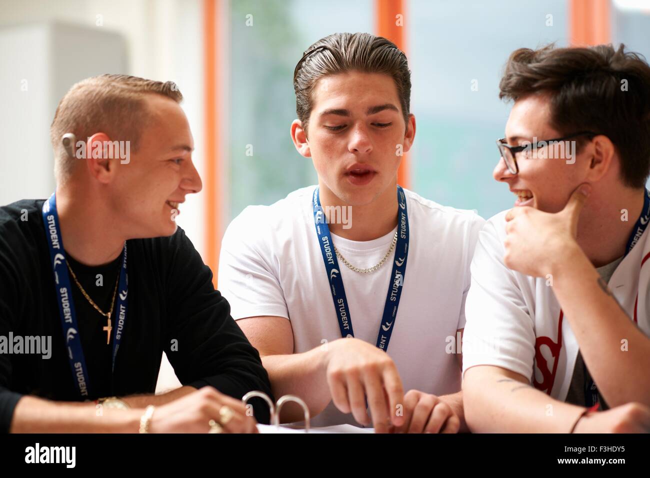 Three male students working together in class Stock Photo