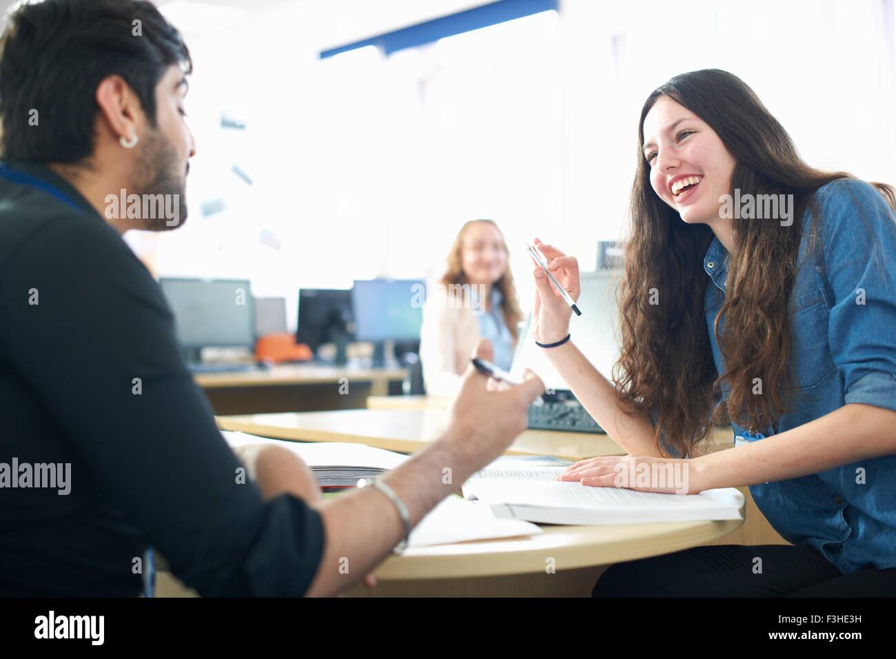 Teacher and female student having classroom tutorial Stock Photo