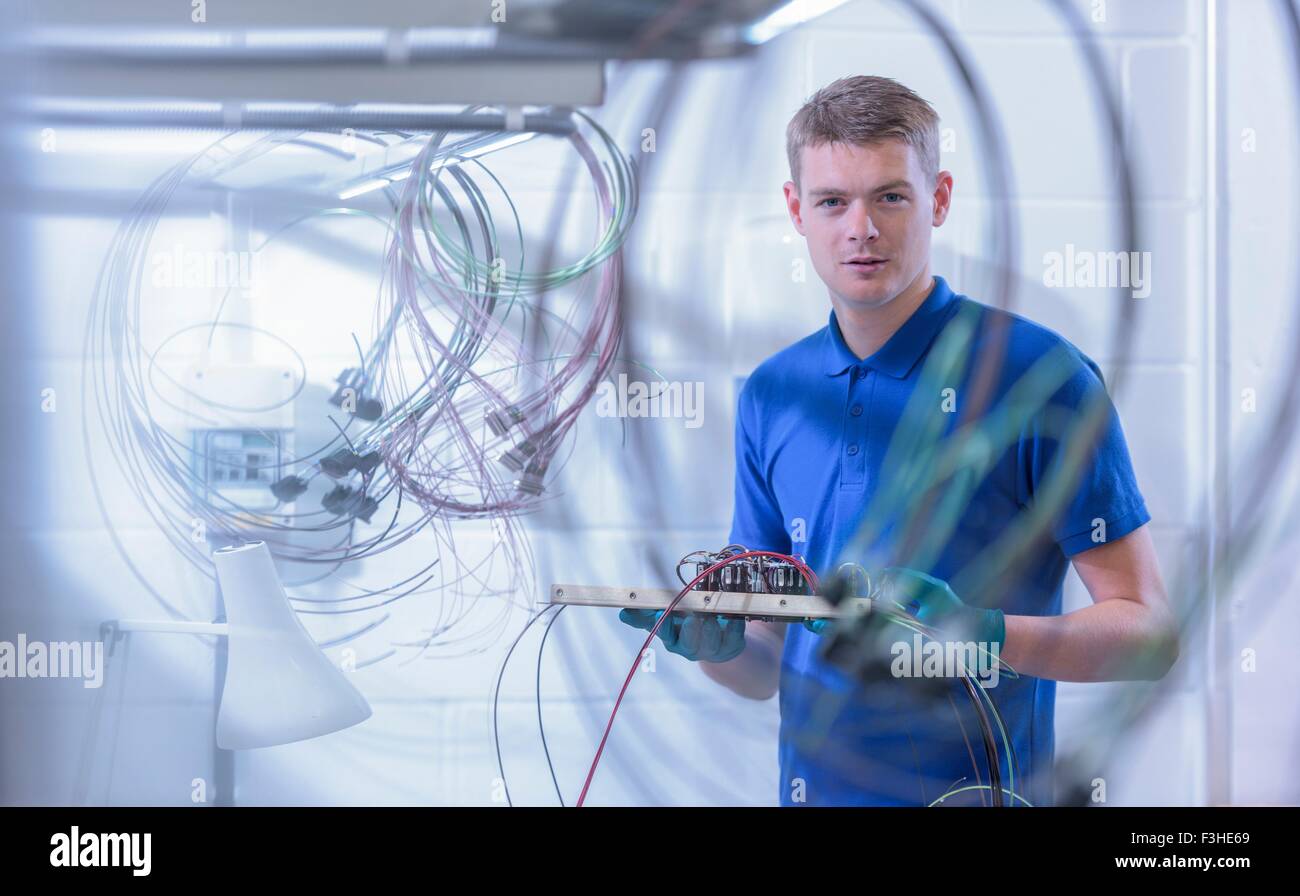 Portrait of apprentice electronics worker in electronics factory, Stock Photo