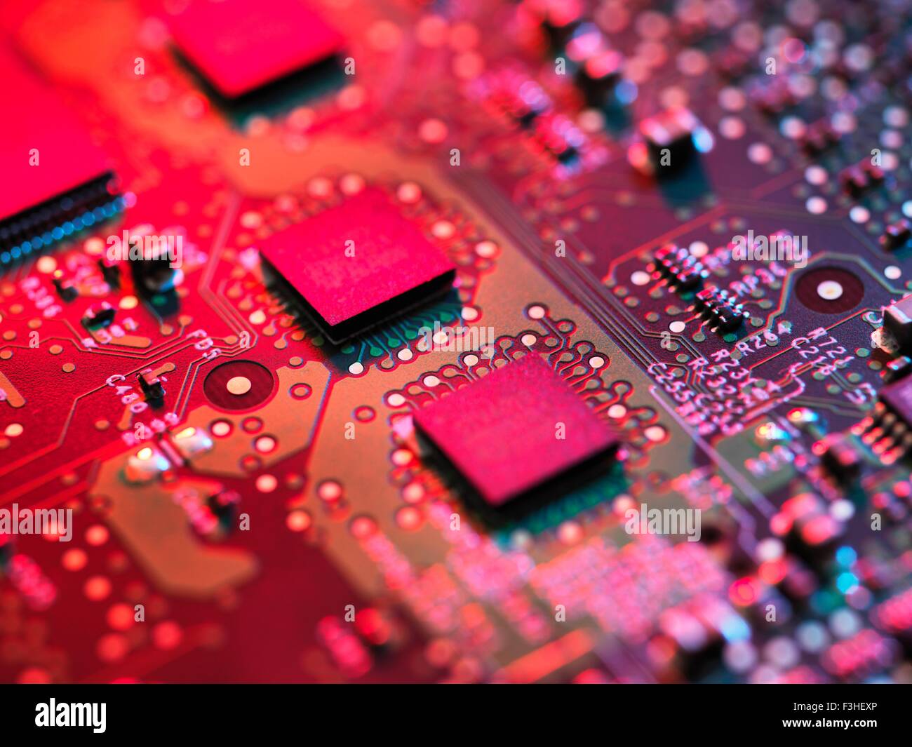 Close up detail of pink computer circuit board Stock Photo