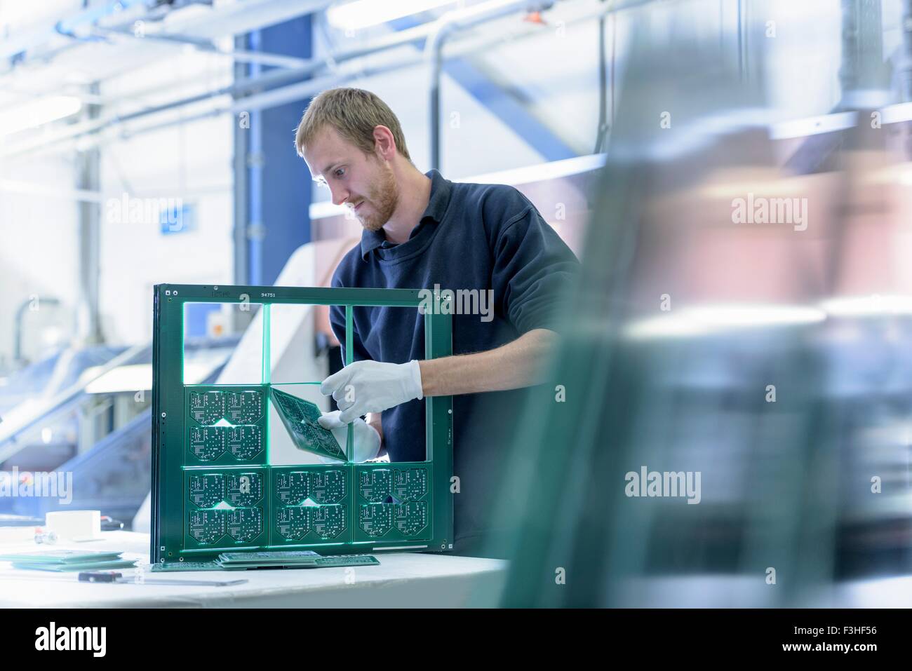 Worker cutting circuit boards in circuit board factory Stock Photo Alamy