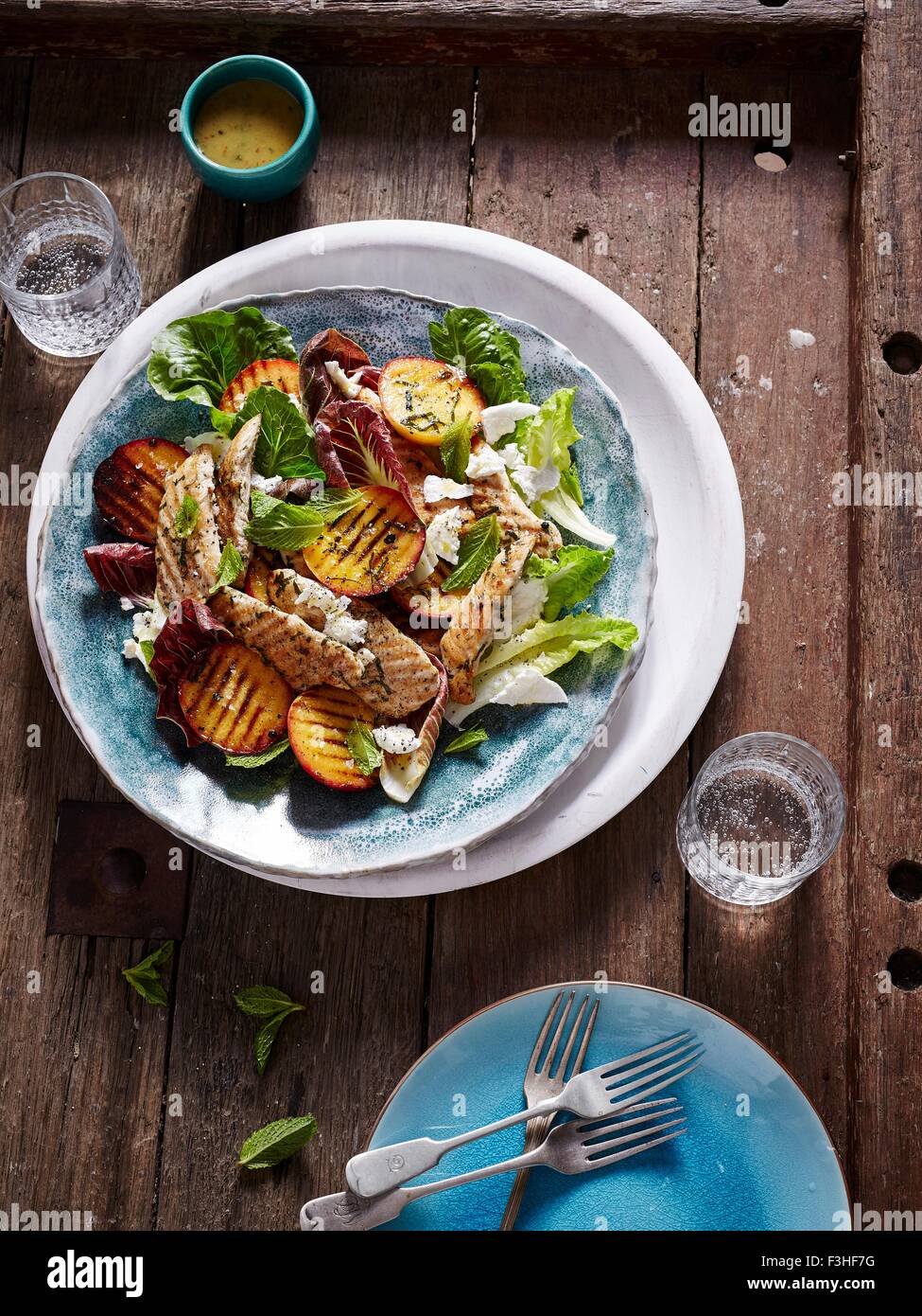 BBQ chicken, peach and cos lettuce salad Stock Photo